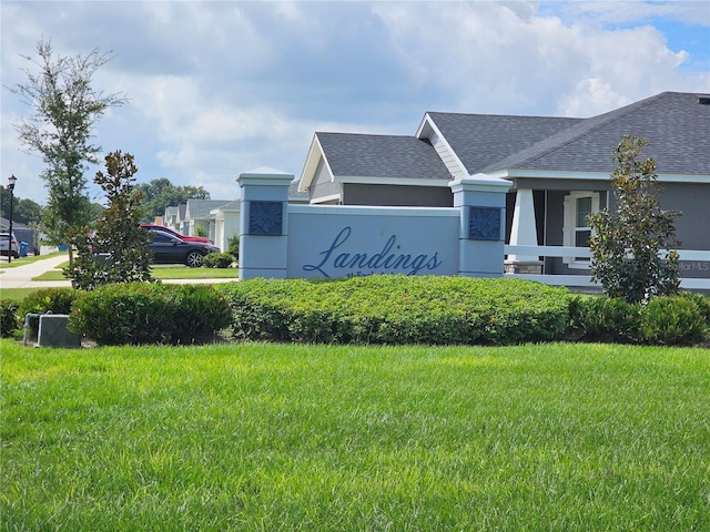 community / neighborhood sign with a yard