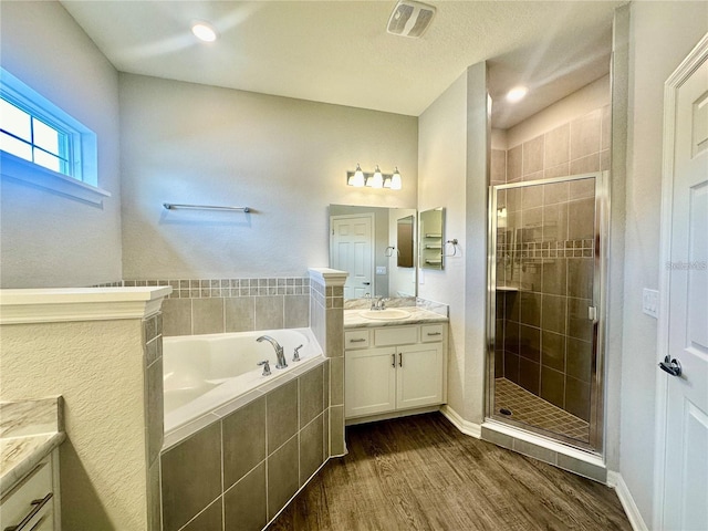 bathroom featuring vanity, plus walk in shower, and hardwood / wood-style flooring