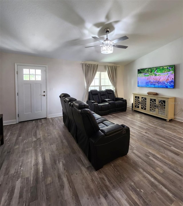 living room with vaulted ceiling, dark hardwood / wood-style flooring, plenty of natural light, and ceiling fan