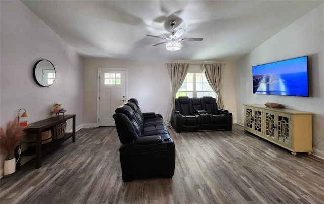 living room featuring dark wood-type flooring, ceiling fan, vaulted ceiling, and a wealth of natural light