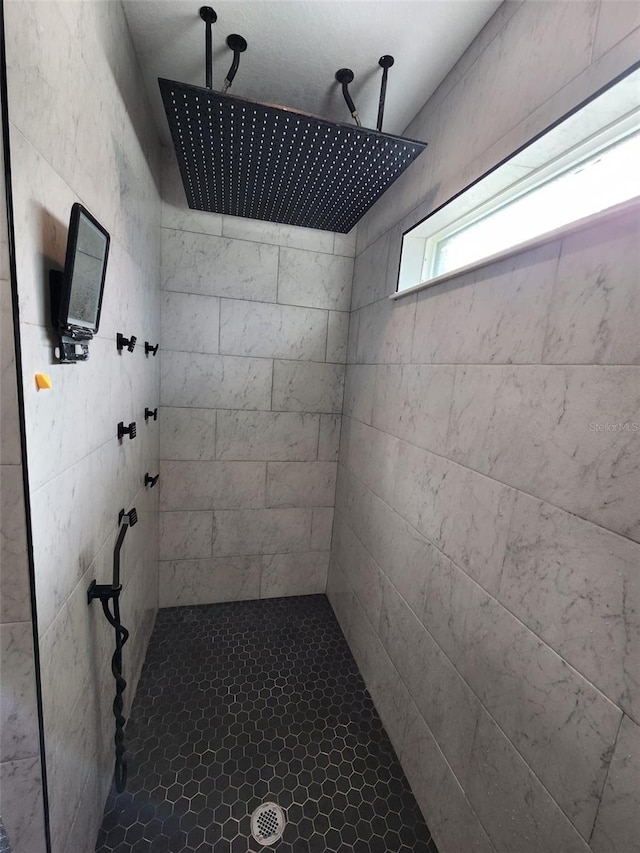 bathroom with tiled shower