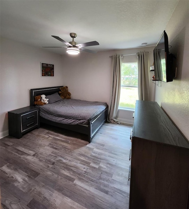 unfurnished bedroom with light hardwood / wood-style flooring and ceiling fan