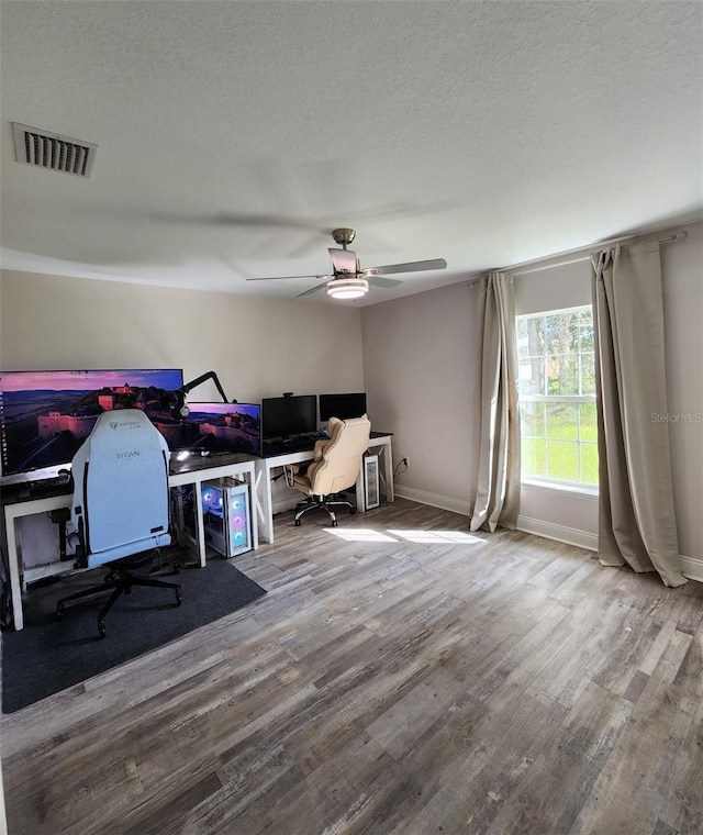 office with ceiling fan, a textured ceiling, and hardwood / wood-style floors