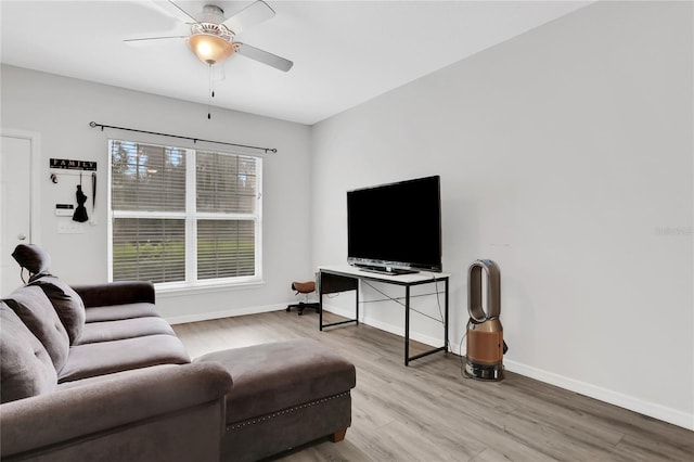 living room featuring wood-type flooring and ceiling fan