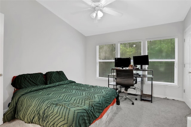 bedroom featuring ceiling fan, vaulted ceiling, and carpet flooring