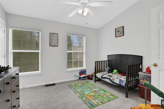 bedroom featuring ceiling fan, light colored carpet, and lofted ceiling