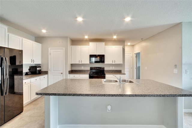 kitchen featuring white cabinets, sink, a textured ceiling, a center island with sink, and black appliances