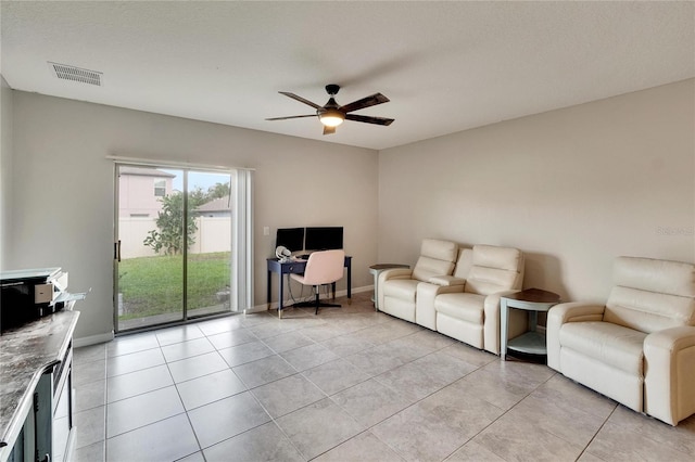 living room featuring ceiling fan and light tile patterned floors