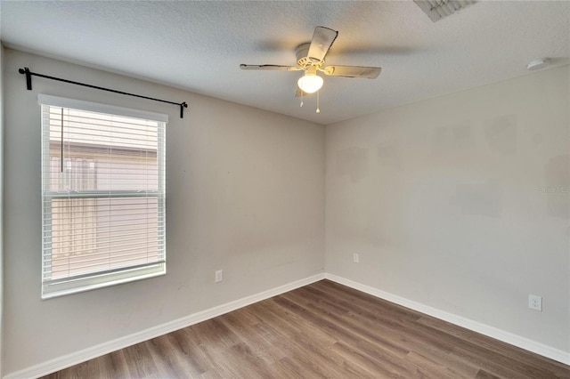 unfurnished room featuring a healthy amount of sunlight and hardwood / wood-style flooring