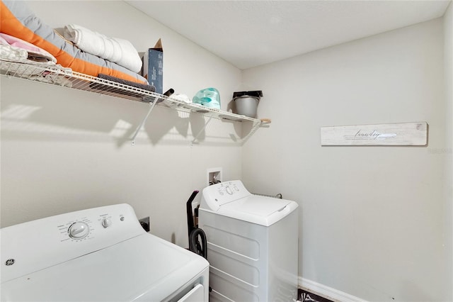 clothes washing area featuring washer and clothes dryer