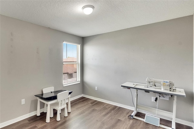 office space with a textured ceiling and hardwood / wood-style flooring