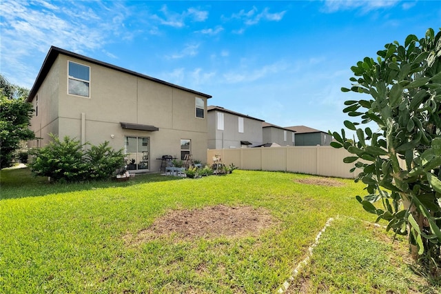 back of property featuring a yard and a patio area