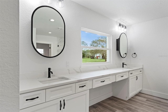 bathroom with hardwood / wood-style flooring and vanity