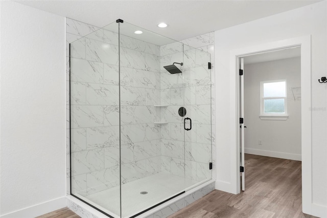 bathroom featuring walk in shower and hardwood / wood-style floors