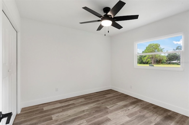 unfurnished room with ceiling fan and hardwood / wood-style floors