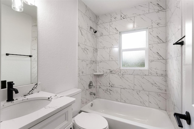 full bathroom featuring vanity, tiled shower / bath, and toilet