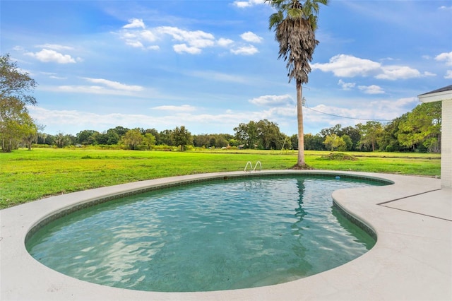 view of pool featuring a yard