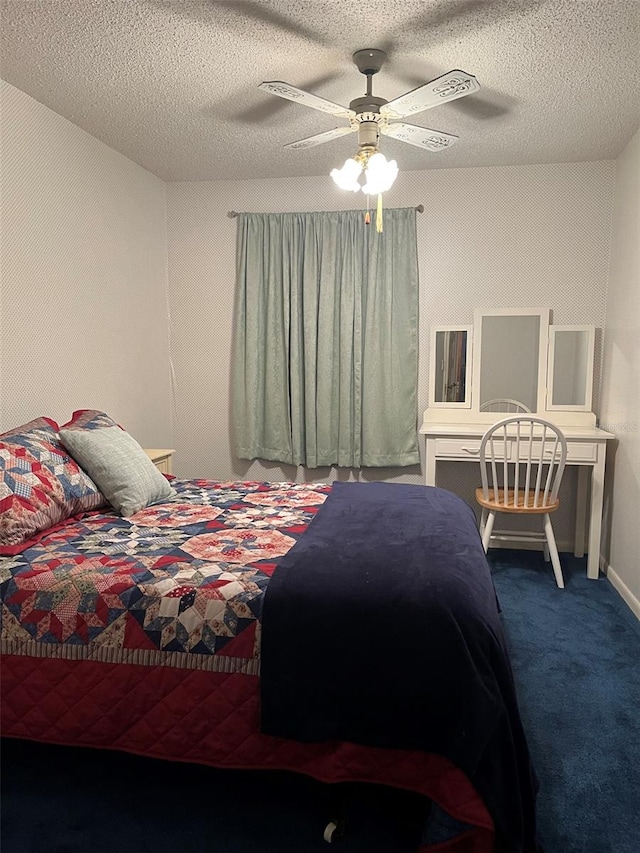 carpeted bedroom featuring ceiling fan and a textured ceiling