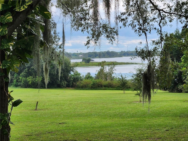 exterior space featuring a water view and a yard