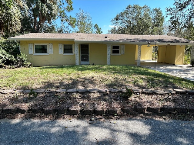 single story home featuring a carport and a front yard