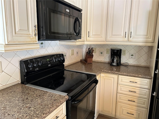 kitchen featuring tasteful backsplash, black appliances, dark stone counters, and cream cabinetry