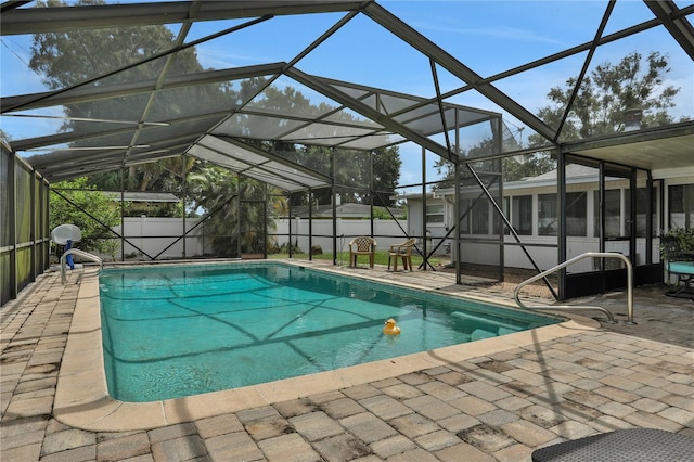 view of swimming pool featuring a patio and a lanai