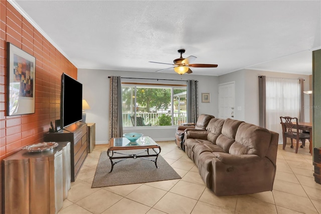 living room featuring ornamental molding, ceiling fan, and light tile patterned floors