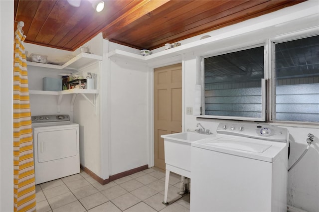 clothes washing area with separate washer and dryer, light tile patterned flooring, and wooden ceiling