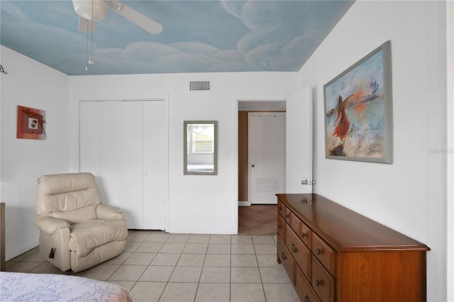 living area featuring ceiling fan and light tile patterned floors