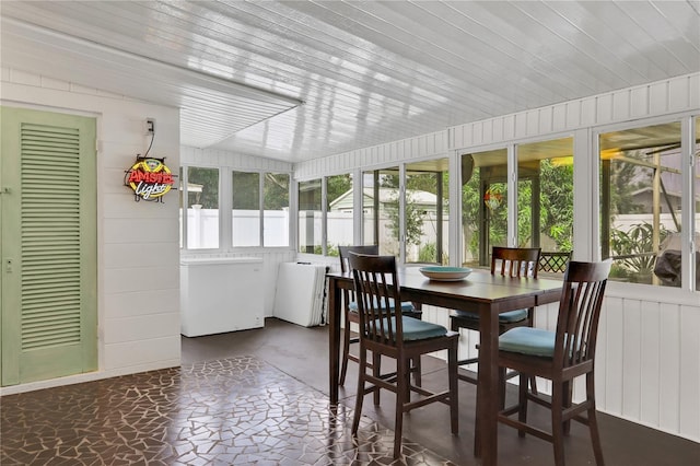 sunroom with lofted ceiling and wooden ceiling