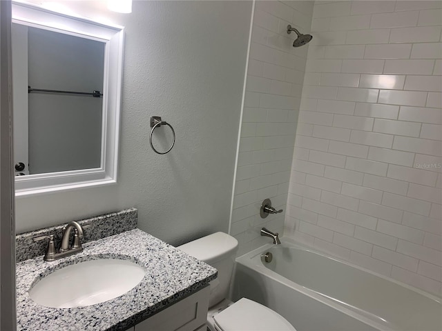 full bathroom with vanity, toilet, and tiled shower / bath