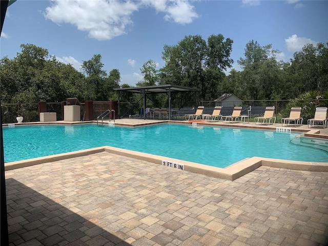 view of swimming pool with a patio