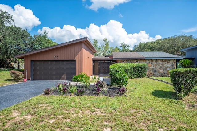 view of front of property with a garage and a front lawn