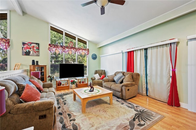 living room featuring lofted ceiling with beams, hardwood / wood-style floors, ceiling fan, and plenty of natural light