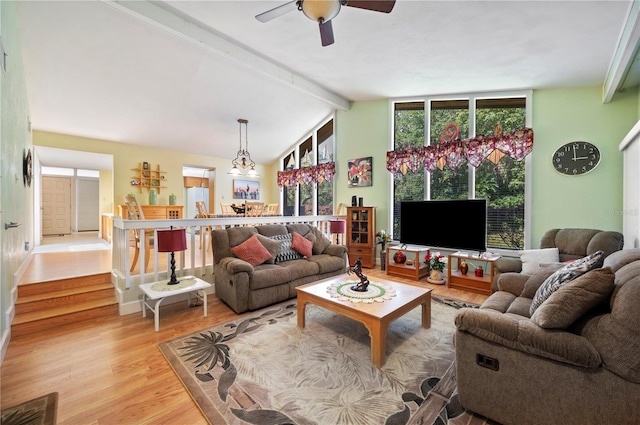 living room with vaulted ceiling with beams, light hardwood / wood-style floors, and ceiling fan