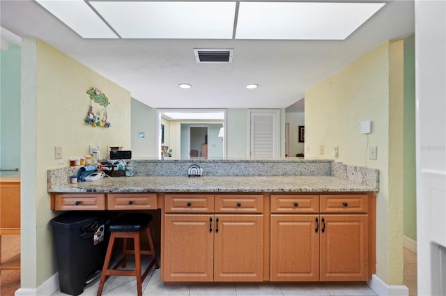 bathroom with tile patterned flooring and vanity