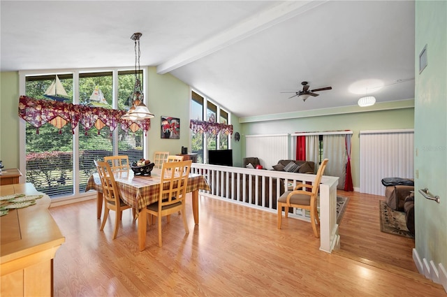 dining area featuring lofted ceiling with beams, ceiling fan, and light hardwood / wood-style flooring