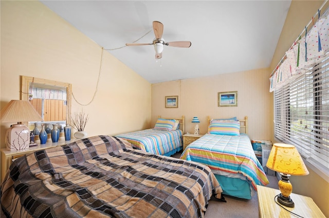 bedroom with ceiling fan, lofted ceiling, and carpet flooring