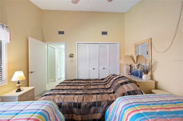 bedroom featuring a high ceiling, a closet, and ceiling fan