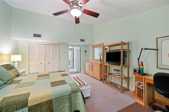 carpeted bedroom featuring ceiling fan and a closet