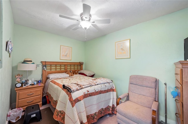 bedroom with ceiling fan and a textured ceiling