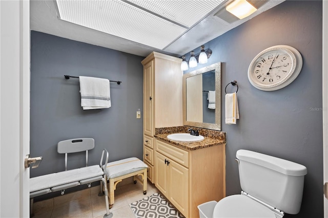 bathroom with tile patterned flooring, vanity, and toilet