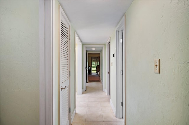 hallway with light tile patterned floors