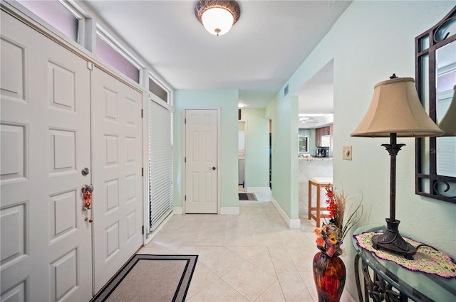 entryway with light tile patterned floors and plenty of natural light