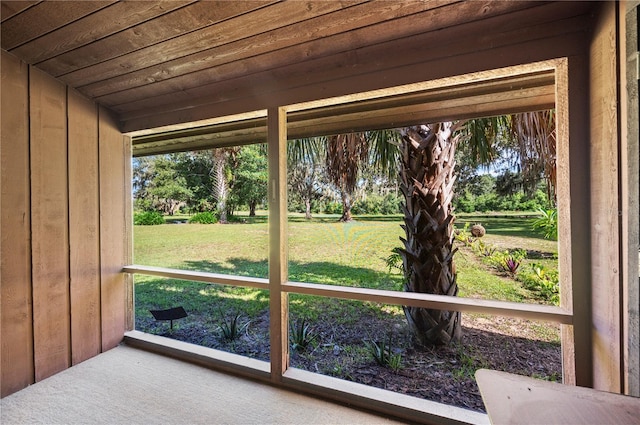 unfurnished sunroom with wood ceiling and a healthy amount of sunlight