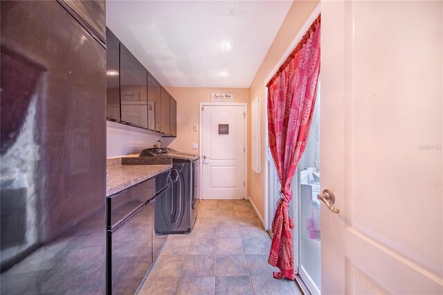 34415 Kingfish St, Fruitland Park, FL 34731 - laundry area with cabinet space, separate washer and dryer, stone finish floors, and baseboards
