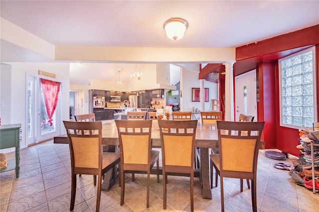 dining area featuring decorative columns