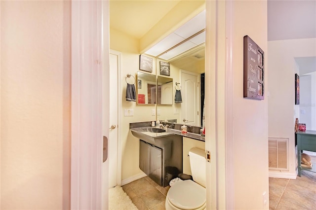 bathroom featuring tile patterned floors, vanity, and toilet