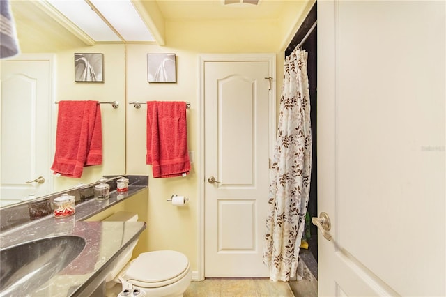 bathroom with walk in shower, vanity, and toilet