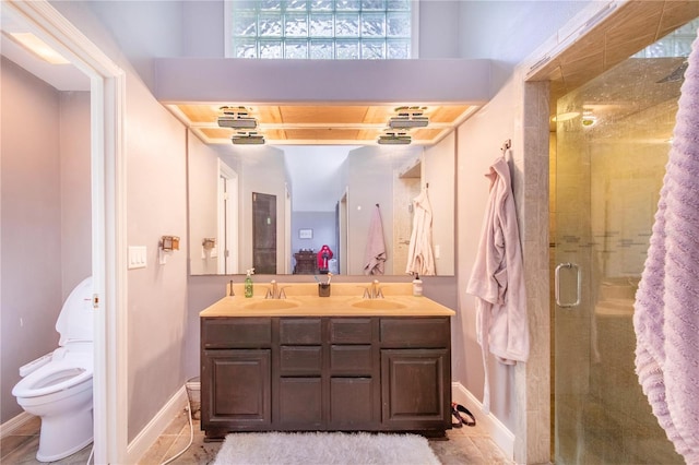 bathroom with vanity, toilet, a shower with door, and tile patterned floors